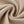 Light Apricot acid wash fabric twisted into a swirl, close-up of the soft knit used for the graphic tee