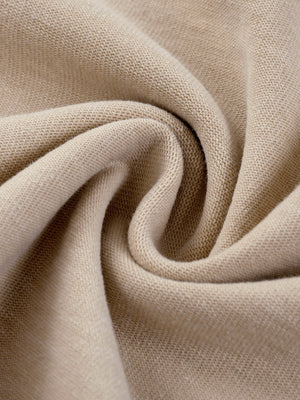 Light Apricot acid wash fabric twisted into a swirl, close-up of the soft knit used for the graphic tee