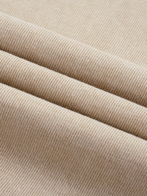 Folds of the Light Apricot acid wash jersey in close-up, fine knit texture of the oversized graphic tee