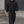 Model walking past a metal shutter in the zipped oversized black hoodie and cargo pants, grey seams visible