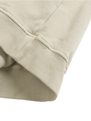 Close-up of the Apricot hoodie where the ribbed cuff meets the sleeve, showing the thick knit rib and seams
