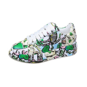 Green painted platform sneaker, side view of the green and red cartoon print and white laces