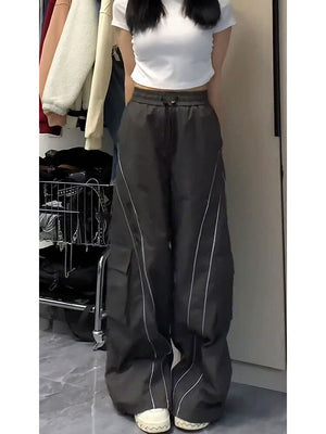 Front view in a white tee, high drawstring waist and wide legs with piping, a cargo pocket on the outer thigh