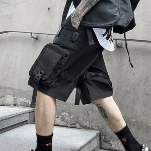 Black paratrooper techwear shorts with cargo pockets and straps