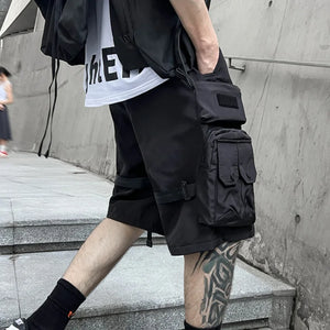Black paratrooper techwear shorts with cargo pockets and straps