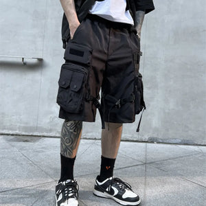 Black paratrooper techwear shorts with cargo pockets and straps