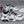 White Black pair of the pastel basketball sneakers on carpet, mint outsole and black trims