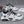 White Black pastel cyberpunk sneakers, white upper with black lacing details and blue heel tab