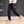 Black Patch Pocket Techwear Joggers on a man walking, side view of the thigh cargo pocket and the ankle cuffs