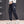 Sapphire Blue techwear cargo joggers in three-quarter view, patch pocket with white label and grey sneakers