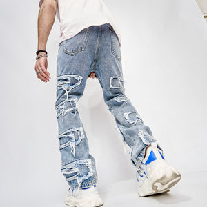 Back view of the light blue patchwork jeans on a model, a back pocket and ripped denim patches, white tee