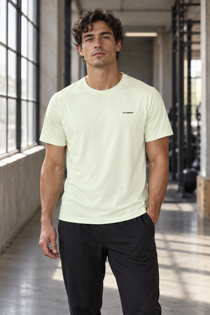 Light Green workout tee on a man in a gym, front view with crew neck and small chest wordmark