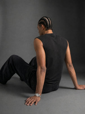 Seated back view, the panel left plain so the washed black reads flat across the shoulders