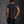 Back view standing, the body hanging loose and finishing straight below the waistband