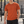Orange workout t-shirt on a man in an outdoor gym, front view with crew neck and small chest logo