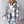 Light Gray plaid hooded jacket with white and caramel lines, front view, worn loose over jeans