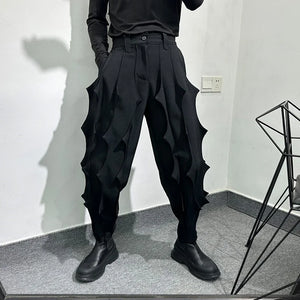 Black pleated harem pants in cotton with tassel detailing