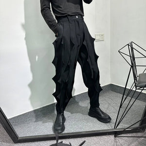 Black pleated harem pants in cotton with tassel detailing