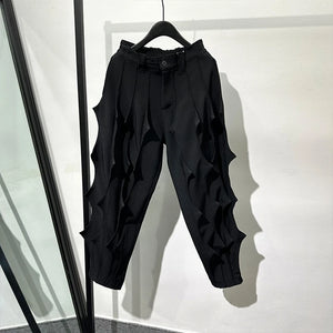 Black pleated harem pants in cotton with tassel detailing