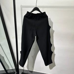 Black pleated harem pants in cotton with tassel detailing
