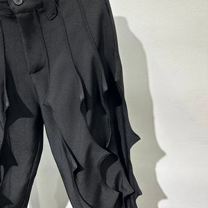 Black pleated harem pants in cotton with tassel detailing