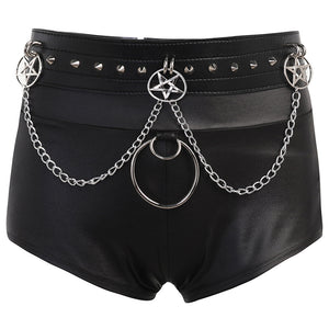 Black PU leather goth shorts laid flat, front view with spiked belt, pentagram rings and a large O-ring