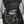 Side view of the PU leather goth shorts on a model in a black top, chains hanging from pentagram rings