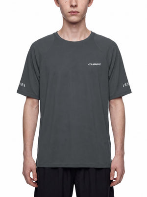 Man in the Dark Gray Reflective Running Raglan Shirt, front view with reflective stripes on both sleeves