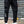 Second front view of the black cargo joggers with dark camo side panels, white shin stripes and ribbed cuffs