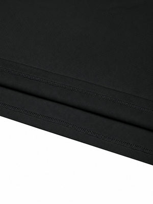 Close-up of the double stitched bottom hem on the black reflective trim gym T-shirt
