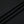 Close-up of the black polyester knit in folds, the smooth fabric of the reflective trim gym tee