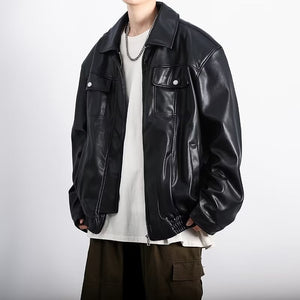Black PU leather jacket with a pointed collar worn over a white tee and chain, front view against white