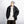 Black PU leather jacket worn open with a grey beanie and chain necklace, angled front view, hands in pockets