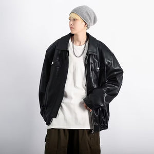 Black PU leather jacket worn open with a grey beanie and chain necklace, angled front view, hands in pockets