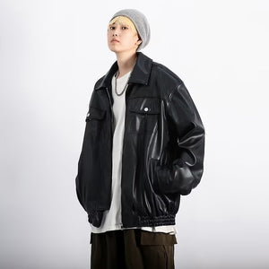 Oversized black PU leather jacket with shirt collar and front zip, three-quarter view with a beanie