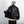 Back view of the black PU leather Y2K jacket held open, showing the yoke seam and gathered elastic hem