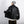 Black oversized PU leather Y2K jacket from the back, sleeve held out to show the loose dropped shoulder