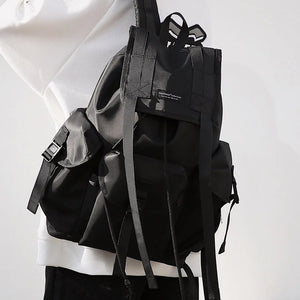 Black tactical techwear backpack with ribbon detailing, 20 to 35 litres