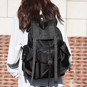 Black tactical techwear backpack with ribbon detailing, 20 to 35 litres