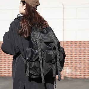 Black tactical techwear backpack with ribbon detailing, 20 to 35 litres