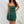 Ruched Bandeau Y2K Dress in green, front view of the strapless ruched bodice with a hand on the hip