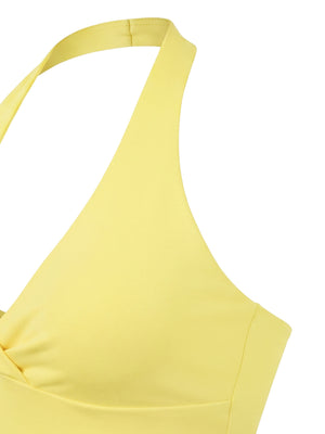 Close-up of the yellow top from the side, the halter strap meeting the bust seam and the shaped cup edge