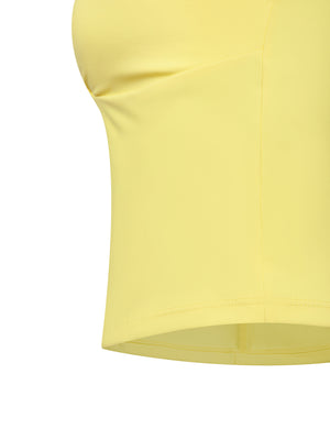 Close-up of the yellow tank top side seam and straight hem, a smooth stretch fabric edge