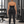 Model in a gym seen from behind wearing the black halter yoga top with black leggings and a CYBER waistband