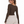 Back three-quarter view of the Coffee bodysuit worn with grey joggers, model glancing over her shoulder