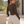 Back view of the Coffee bodysuit tucked into grey sweatpants, model looking over her shoulder outdoors