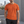 Orange running t-shirt on a man outdoors, front view with crew neck and small dark chest logo