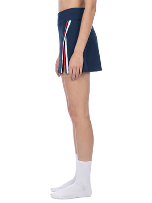 Side view of the Navy Blue tennis skirt on a model, showing the striped trim along the side slit