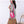 Modella in t-shirt grigia con la borsa a tracolla skeleton rosa acceso con tracolla rosa coordinata, vista laterale