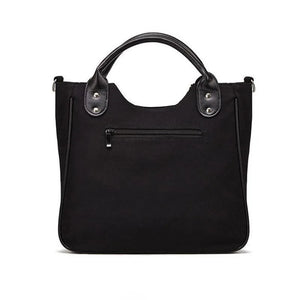 Black tote bag with a pale skeleton ribcage print and a detachable shoulder strap